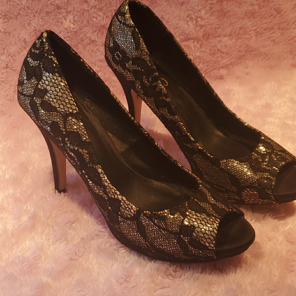 High heeled black and gold open toe shoes